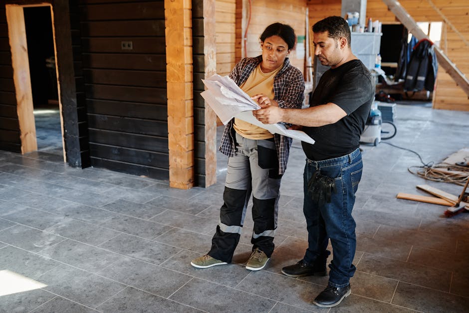 contractor reviewing renovation blueprints homeowner