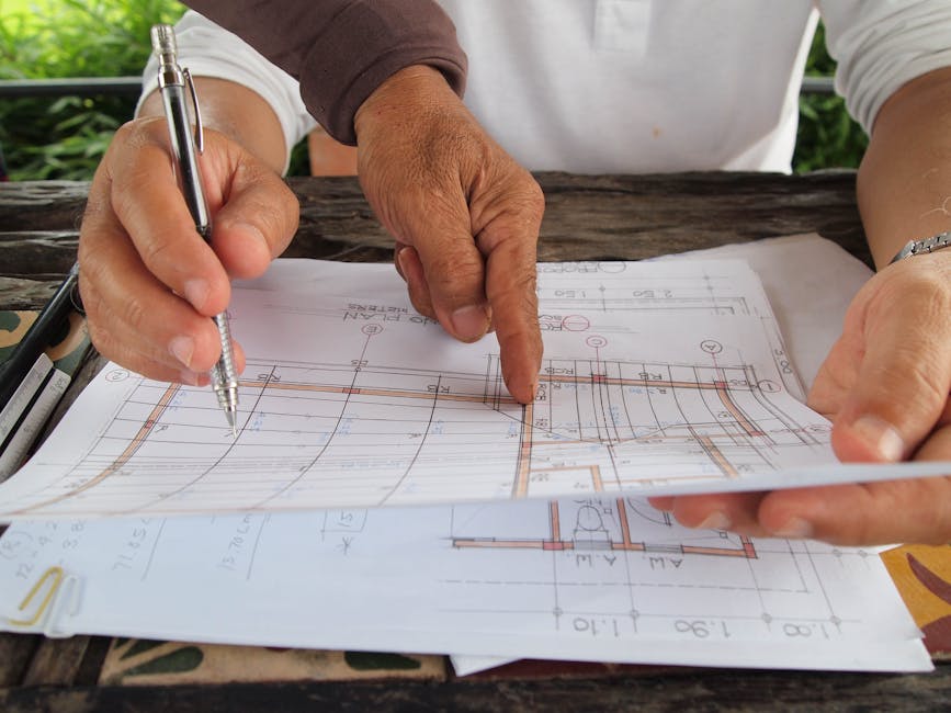 contractor reviewing building plans table